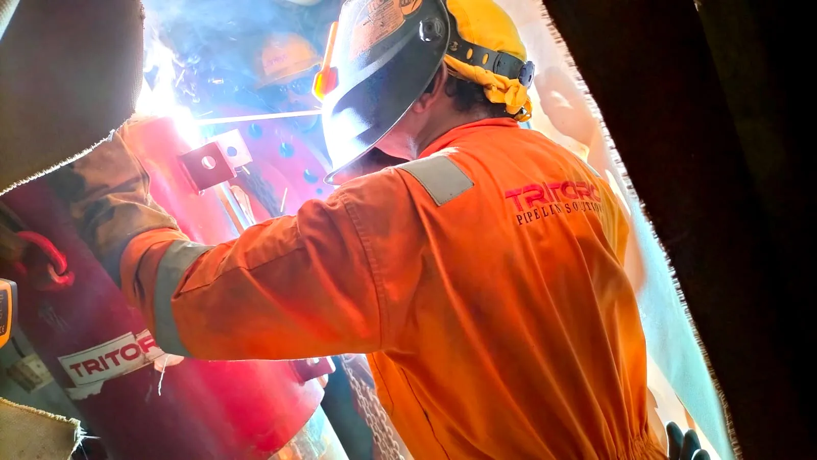 Operator performing long seam welding Operator performing long seam welding